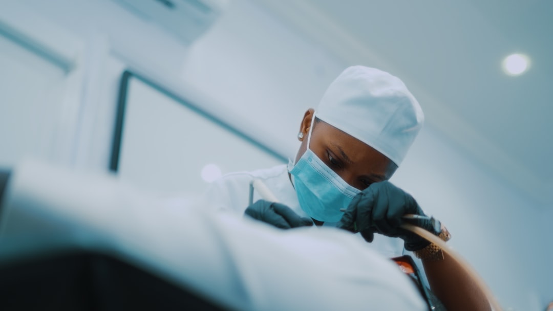 a-person-wearing-a-surgical-mask-and-gloves-i7dxjggacem